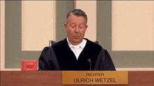 richter ulrich wetzel sits in front of a microphone in a courtroom