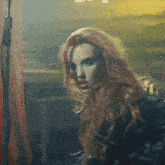 a close up of a woman 's face with red hair