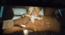a man is holding a gun in front of a woman 's waist .