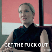 a woman is sitting in a chair with the words get the fuck out written on the bottom