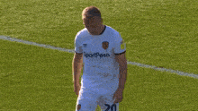 a soccer player wearing a white jersey that says sportpesa on it