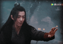 a man with chinese writing on the bottom right corner