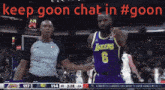 a basketball player wearing a lakers jersey talks to a referee during a game