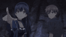 a boy and a girl are standing next to each other in a dark room
