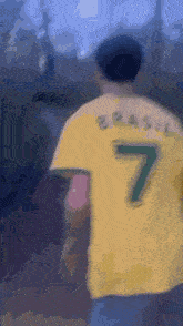 a blurry picture of a person wearing a yellow jersey with the number 7 on the back