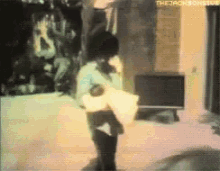 a blurry picture of a man holding a pillow with the words the jackson five written on the bottom
