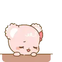 a pink teddy bear is sitting on a table and thinking about a teddy bear .