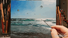 a person is painting a picture of the ocean with the words made in animatica on the bottom right
