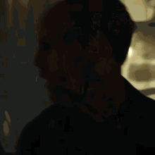 a close up of a man 's face in the dark