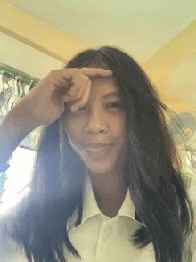 a girl covering her face with her hand and smiling