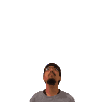 a man with glasses is looking up at a green cross on his head