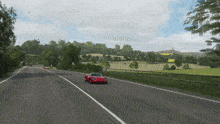 a red sports car is driving down a road in a video game