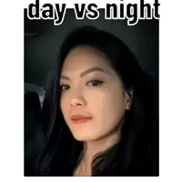 a woman is taking a selfie with the words `` day vs night '' written on the bottom .