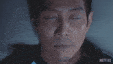 a close up of a man 's face with netflix written on the bottom right