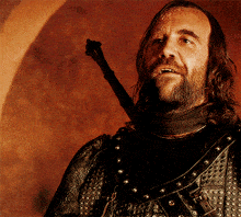a man with a beard is holding a sword