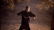 a man in a black jacket is running in the dark