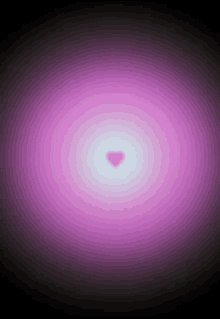 a pink heart is floating in the middle of a purple background .