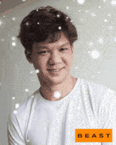 a man wearing a white shirt with the word beast on the bottom right
