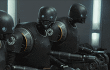 a group of robot soldiers with a star wars logo on their chests