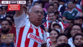 a man in a red and white striped shirt with bimbo on it