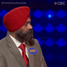 a man wearing a red turban and a name tag that says tony is clapping