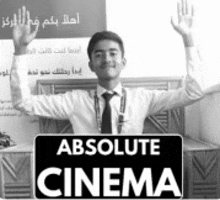a man in a white shirt and black tie holds up his arms in front of a sign that says absolute cinema