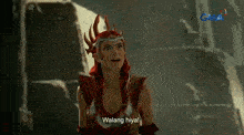 a woman in a red costume is holding a fireball in her hand and says walang hiya
