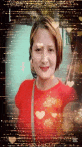 a woman in a red shirt is taking a selfie with hearts in the background .