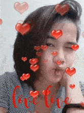 a girl with red hearts around her and the word love in red