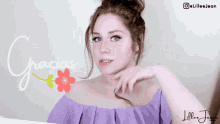 a woman in a purple off the shoulder top says gracias in spanish