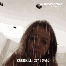 a woman is standing in the rain with instaweather written on the bottom right