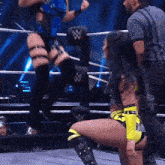 a woman in a wrestling ring with a w on the ropes