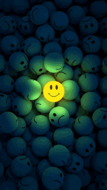 a smiley face is surrounded by sad faces in the dark