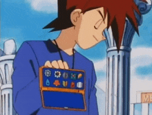 a cartoon character is holding a blue box with a lot of buttons on it in his hands .