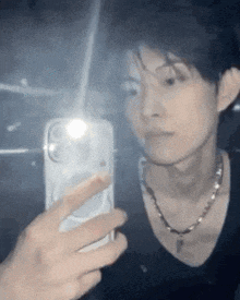 a man is taking a picture of himself in the mirror .