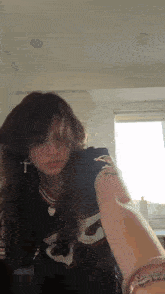 a girl wearing a black shirt with the number 35 on it is taking a selfie .