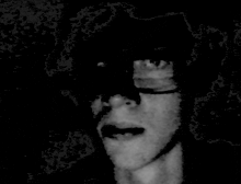 a black and white photo of a man 's face