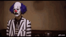 a man dressed as a clown in a striped suit
