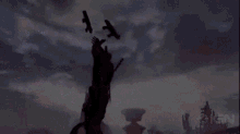 a silhouette of a man holding a gun in the air .