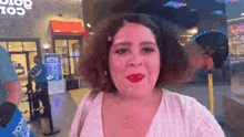 a woman with red lipstick stands in front of a store that says globe 105