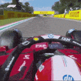 a red race car with the word ibm on the steering wheel is driving down a track