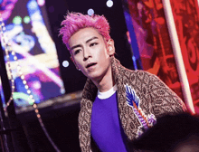 a man with pink hair wearing a purple shirt