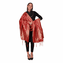 a woman wearing a red dupatta and a black top