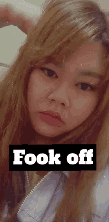a woman 's face is behind a sign that says ' took off '