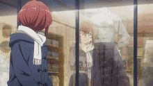 a girl with red hair is looking at a dress in a store window