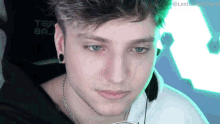 a close up of a man 's face with a green background that says ' lestrange ' on it