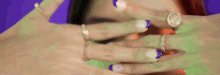 a close up of a person 's hands with rings on them .