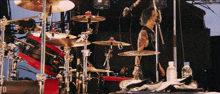 a man with a tattoo on his arm is playing a drum set