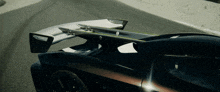 a close up of a car 's wing on the road