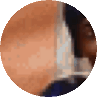 a close up of a person 's face in a circle with a blurry background